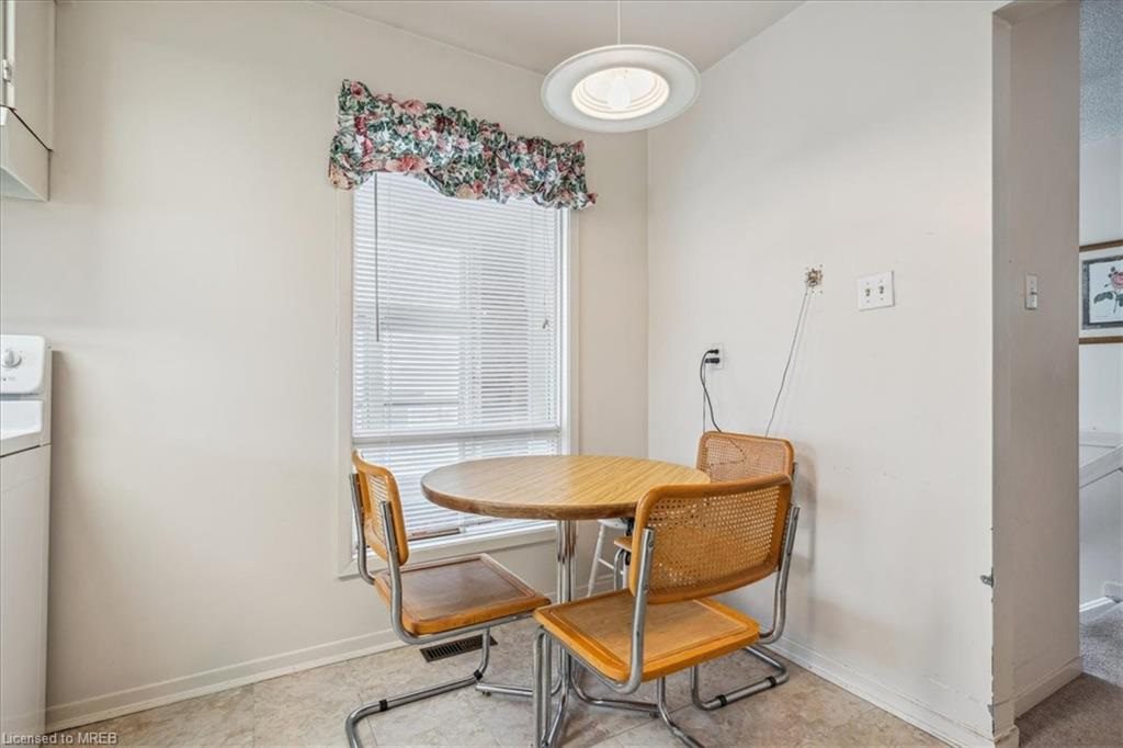 A small table and chairs in the corner of a room.