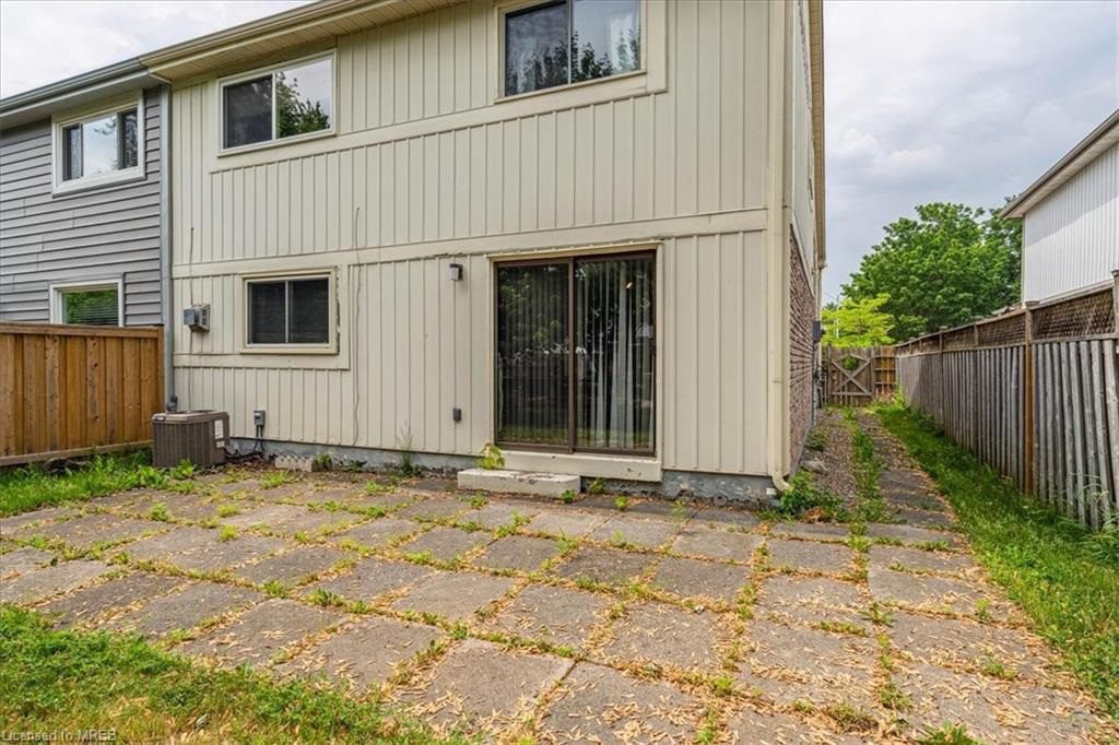 A large house with a patio and concrete driveway.