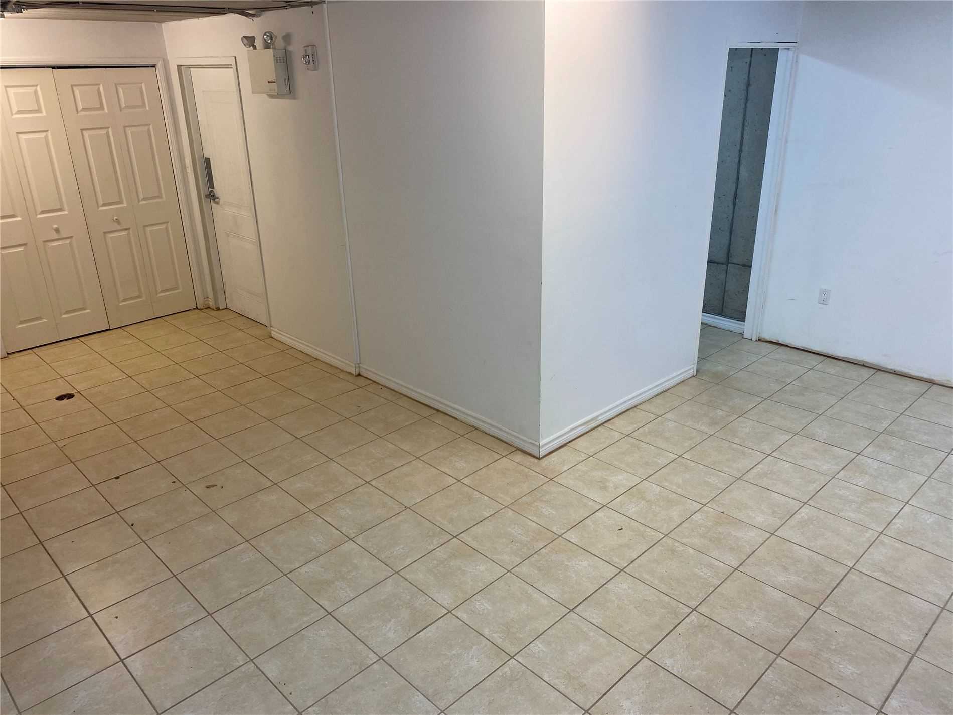 A room with tile floors and white walls.