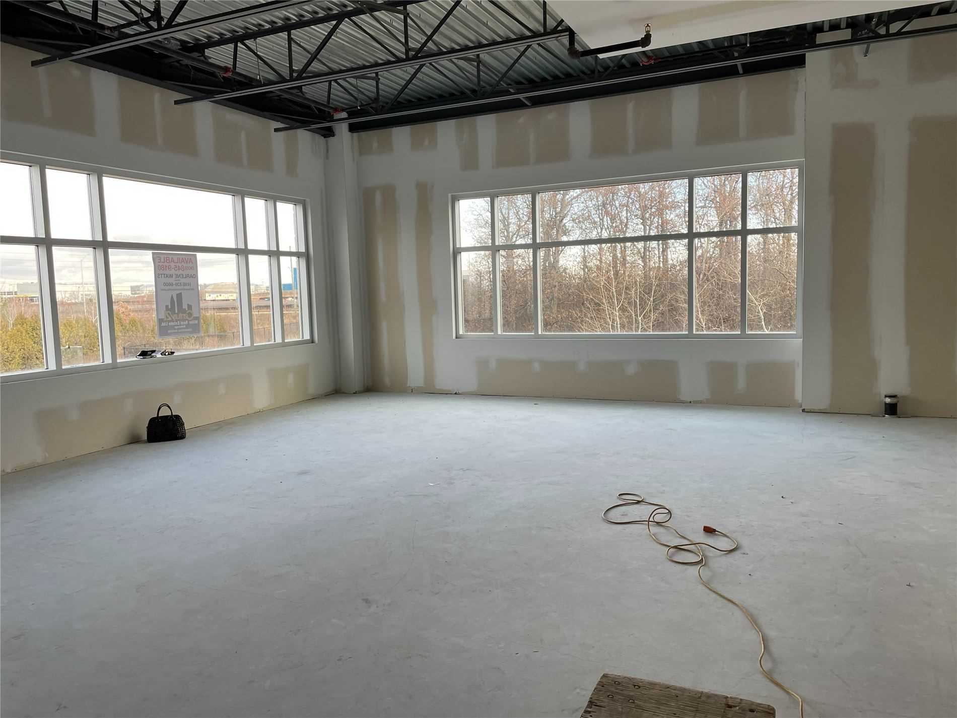 A room with many windows and a bare floor