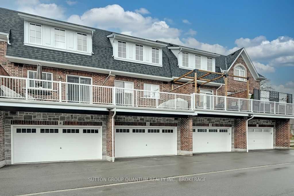 A row of garage doors in front of a brick building.