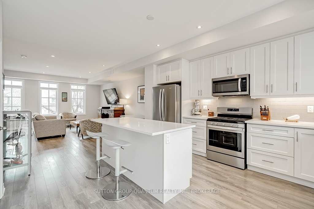 A kitchen with white cabinets and stainless steel appliances.