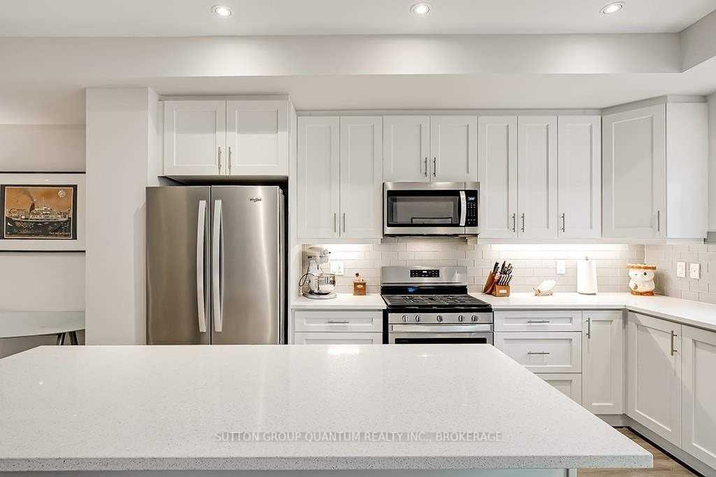 A kitchen with white cabinets and stainless steel appliances.