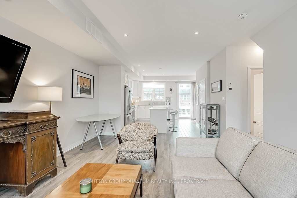 A living room with white walls and wooden floors.