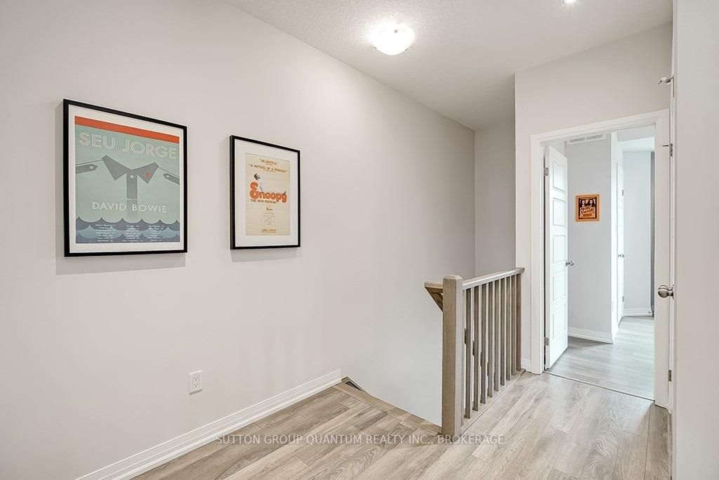 A hallway with two posters hanging on the wall.