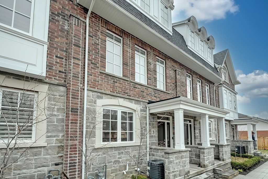 A brick building with a porch and columns.