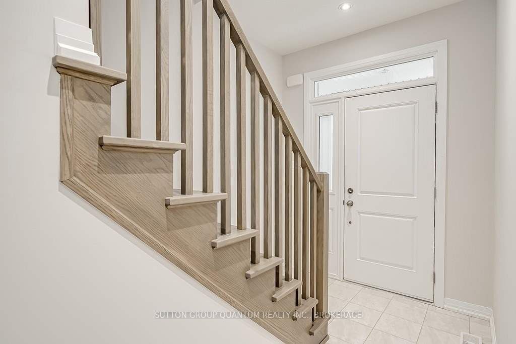 A white door and stairs in the middle of a room.