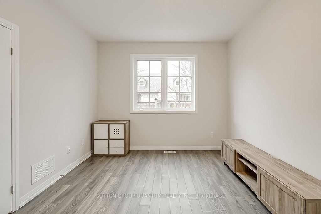 A room with a window and wooden floors