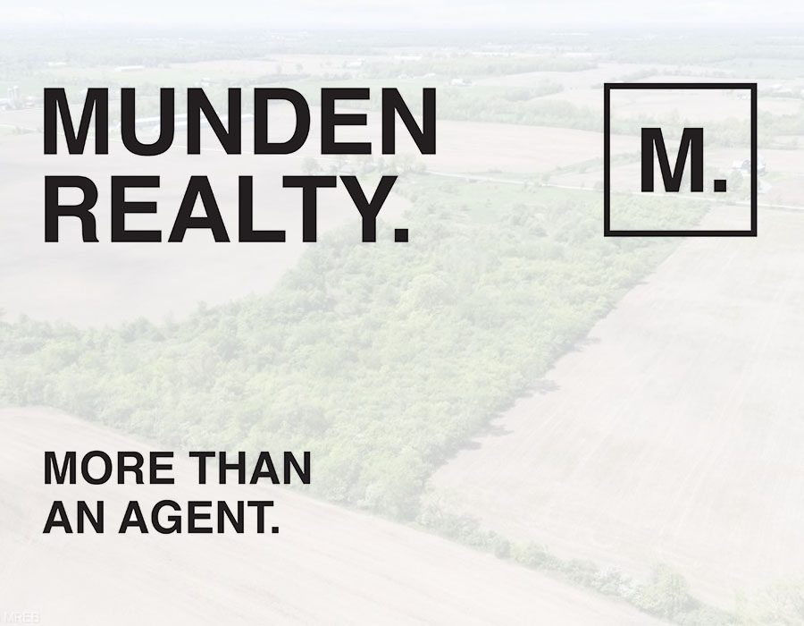 A picture of an open field with the words munden realty on it.