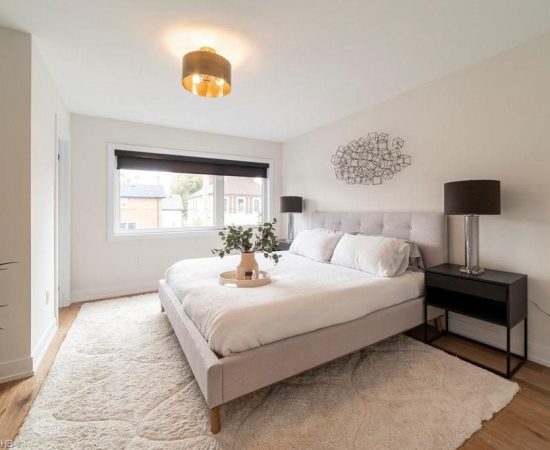 A bedroom with a large bed and white walls