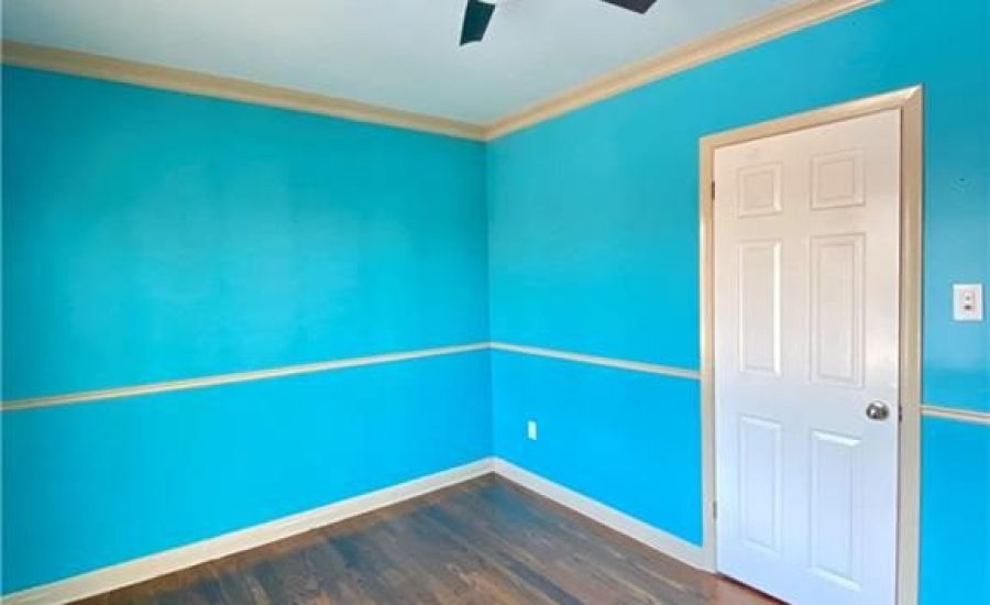 A room with blue walls and wooden floors.