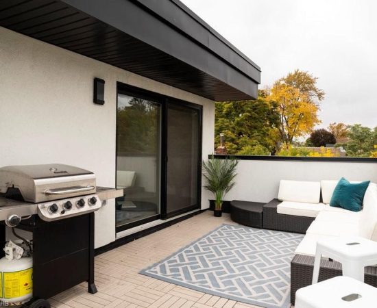 A patio with an outdoor grill and couch