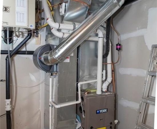 A view of the inside of a home with pipes and wires.