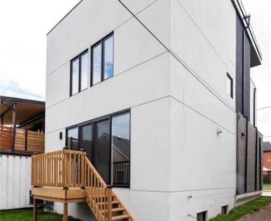 A house with stairs and steps leading to the front door.