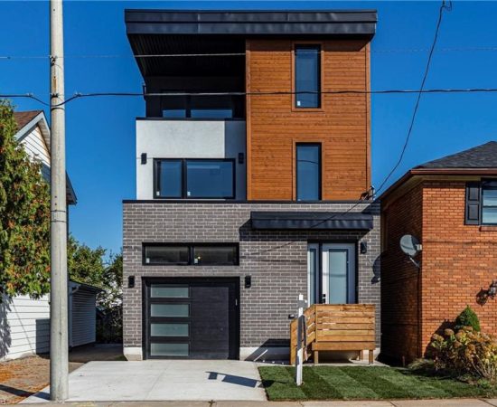 A modern house with a garage and a parking meter.