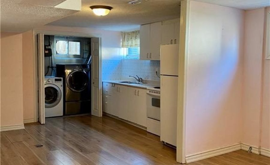 A room with hard wood floors and white walls.