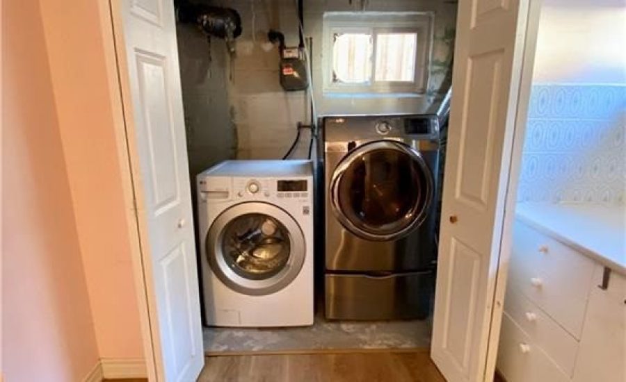 A washer and dryer in the closet of a home.