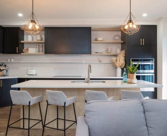 A kitchen with a bar and chairs in it