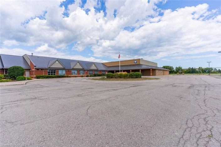 A large empty parking lot with a building in the background.