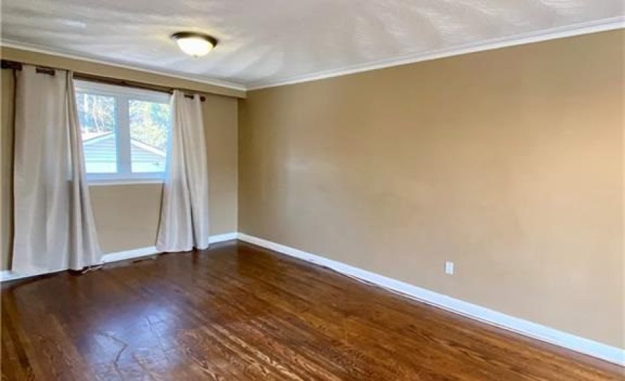 A room with wood floors and white walls.