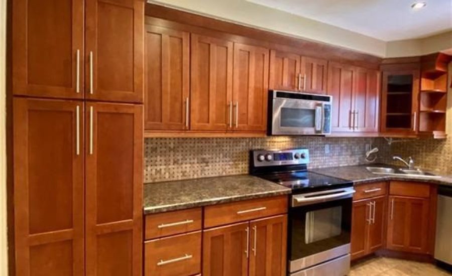 A kitchen with wooden cabinets and stainless steel appliances.