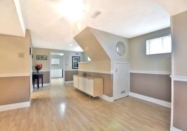 A room with hard wood floors and white walls.