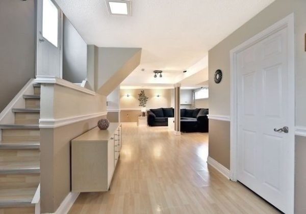 A room with hard wood floors and white walls.