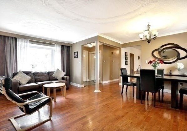 A living room with hard wood floors and furniture.