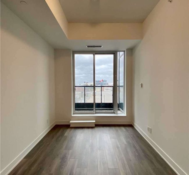 A room with a window and a wooden floor