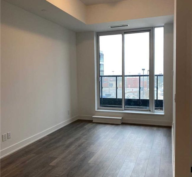 A room with a window and wooden floors