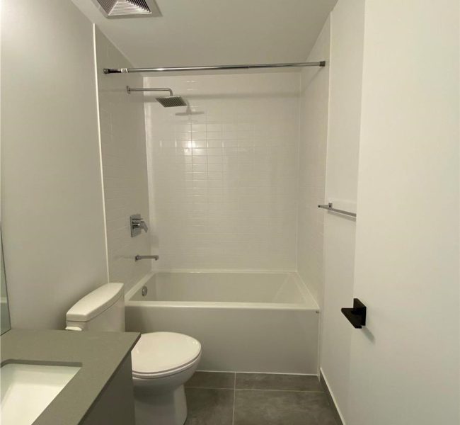 A bathroom with white walls and tile floors.