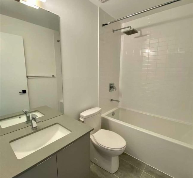 A bathroom with white walls and tile floors.