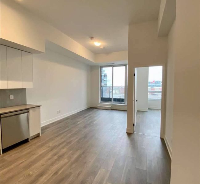 A large open living room with hard wood floors.