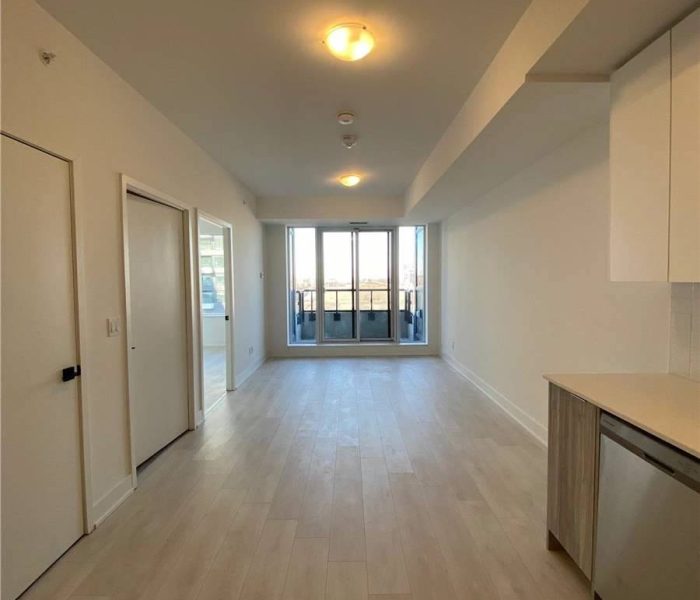 A large open room with white walls and wooden floors.