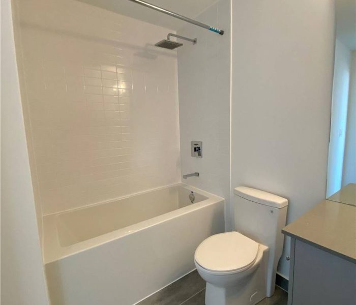 A bathroom with white walls and tile floors.