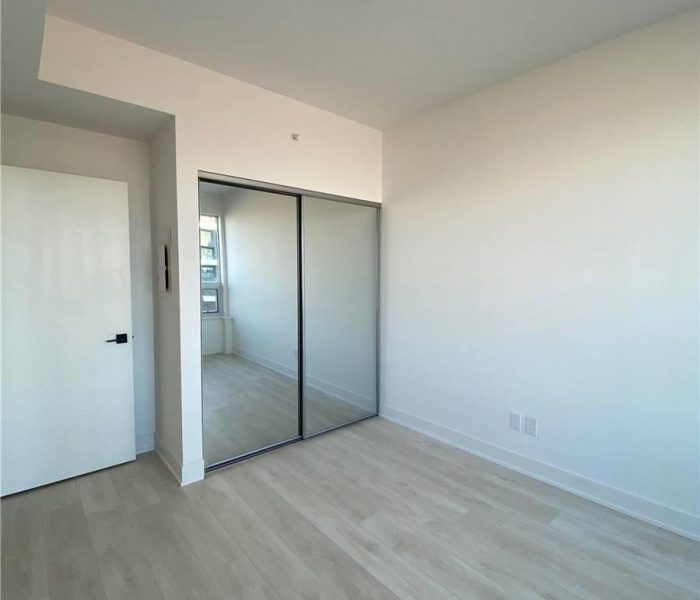 A room with white walls and wooden floors.