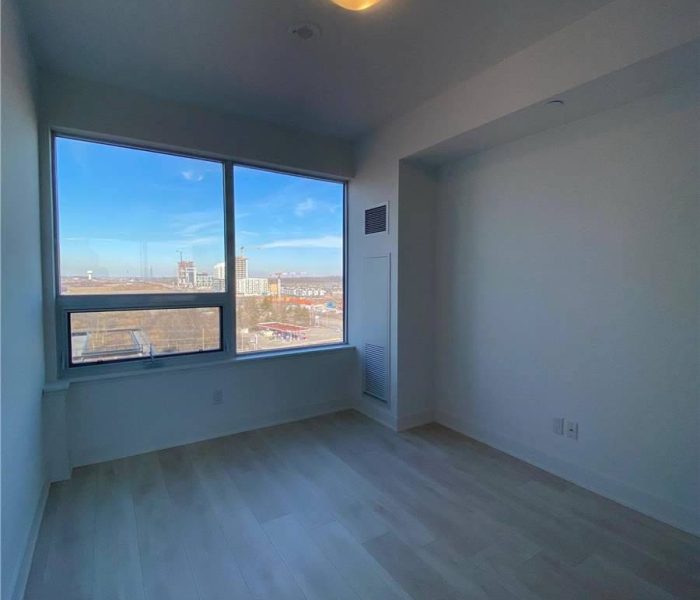 A room with a large window and a view of the mountains.