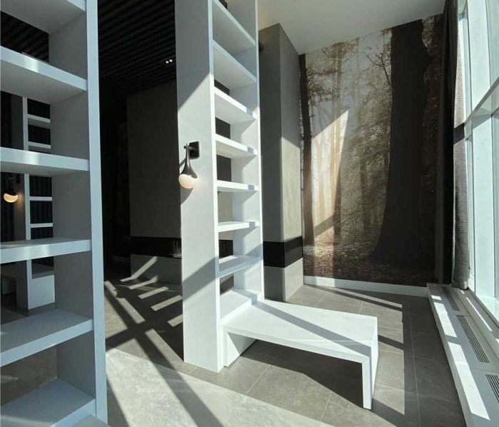 A room with shelves and a window in it