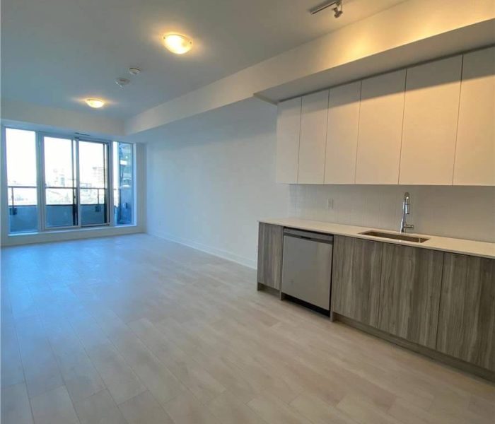 A large open room with white walls and wooden floors.