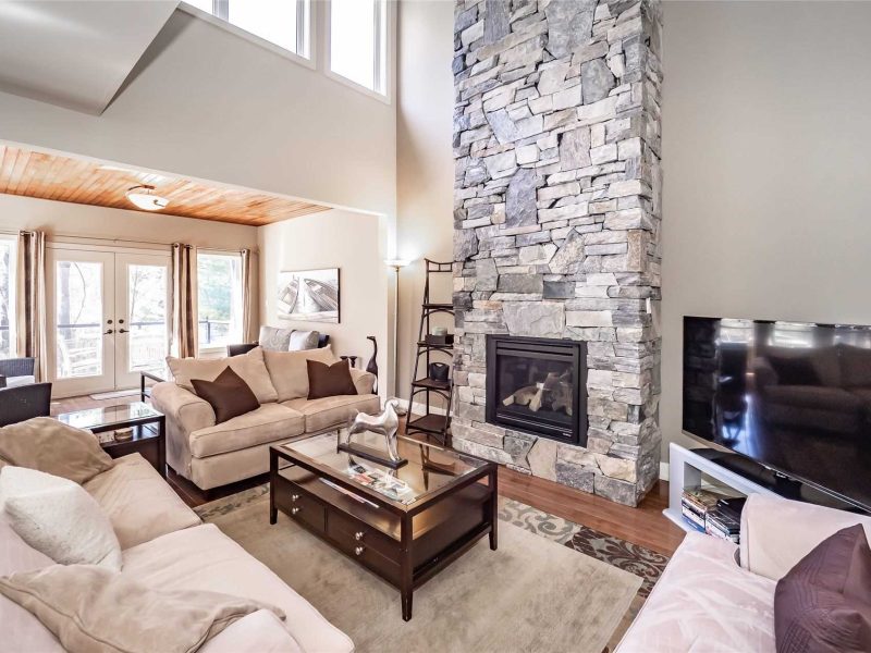 A living room with a fireplace and couches