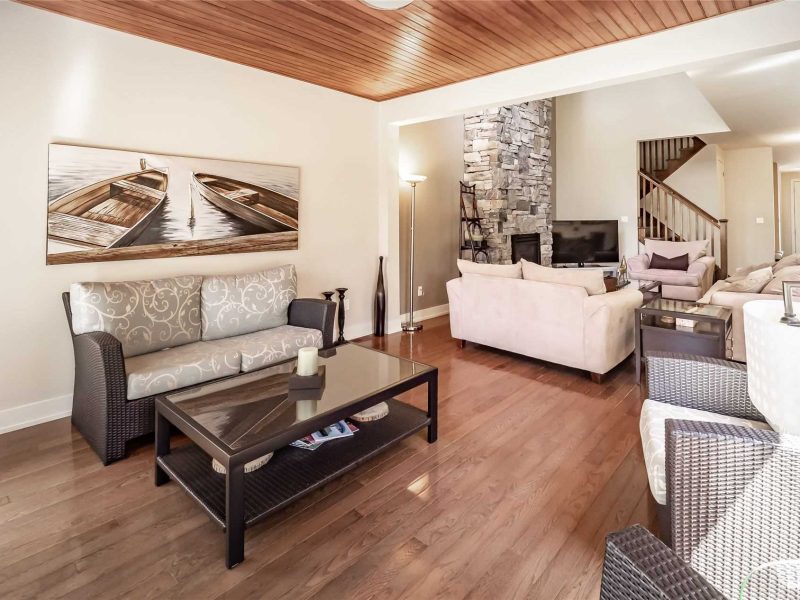 A living room with wood floors and furniture.