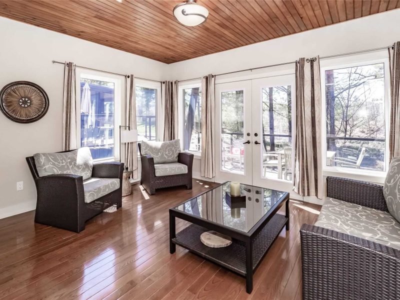 A living room with wooden floors and white walls.