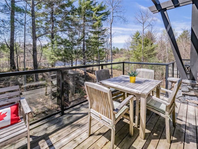 A wooden deck with table and chairs on it