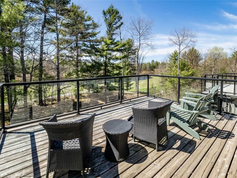 A deck with chairs and tables on it