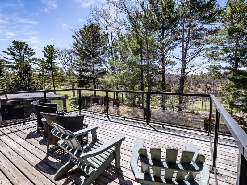 A deck with chairs and tables on it