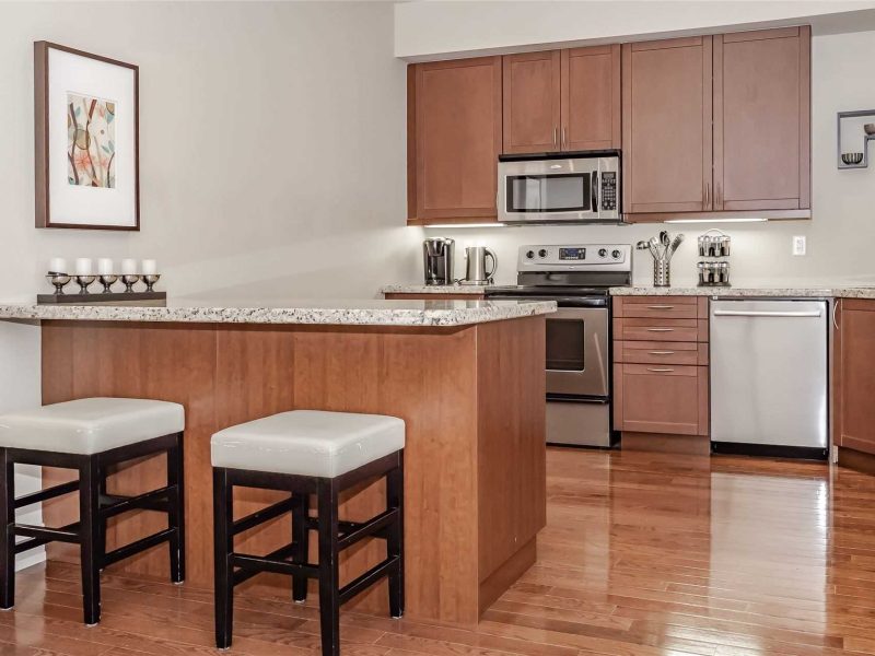 A kitchen with wooden cabinets and white appliances.