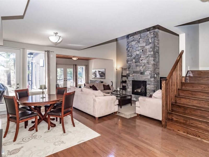 A living room with a fireplace and wooden floors