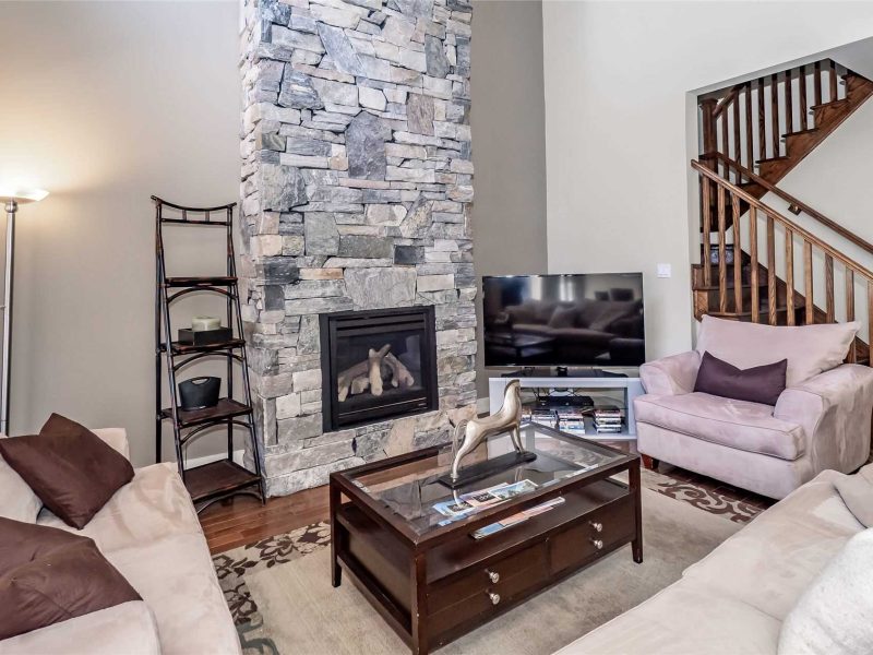 A living room with a fireplace and couches